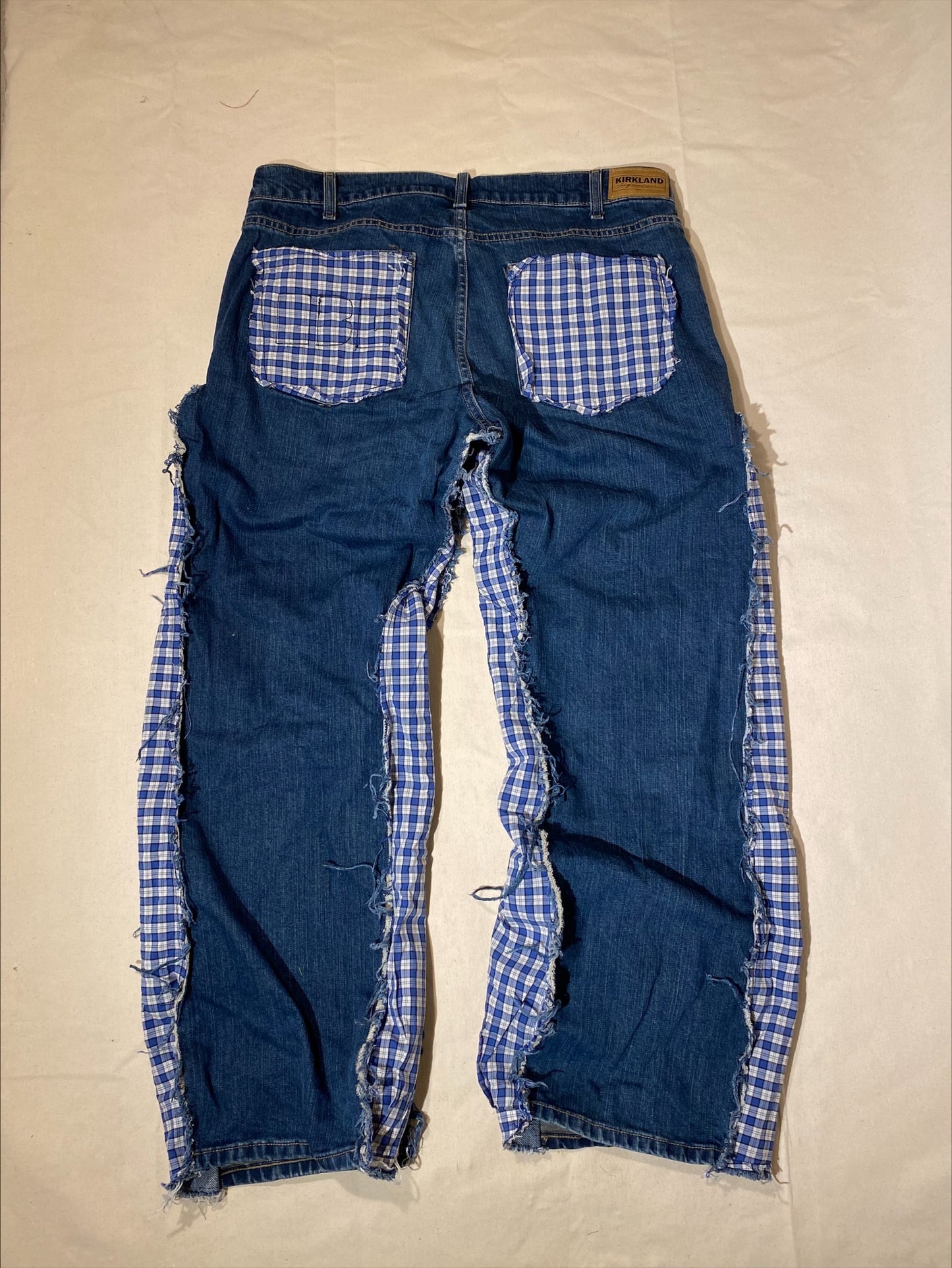 Reworked distressed plaid denim